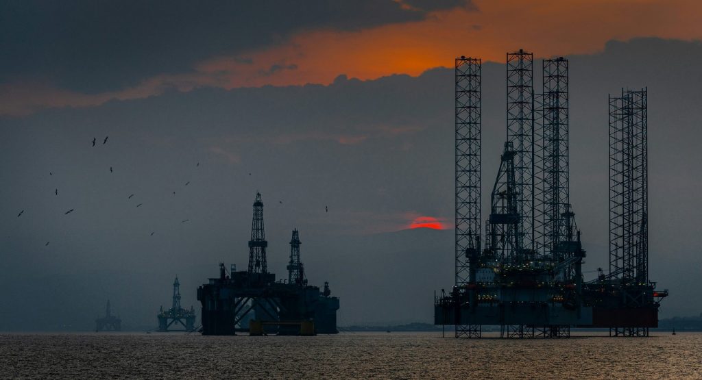 a group of oil rigs in the ocean