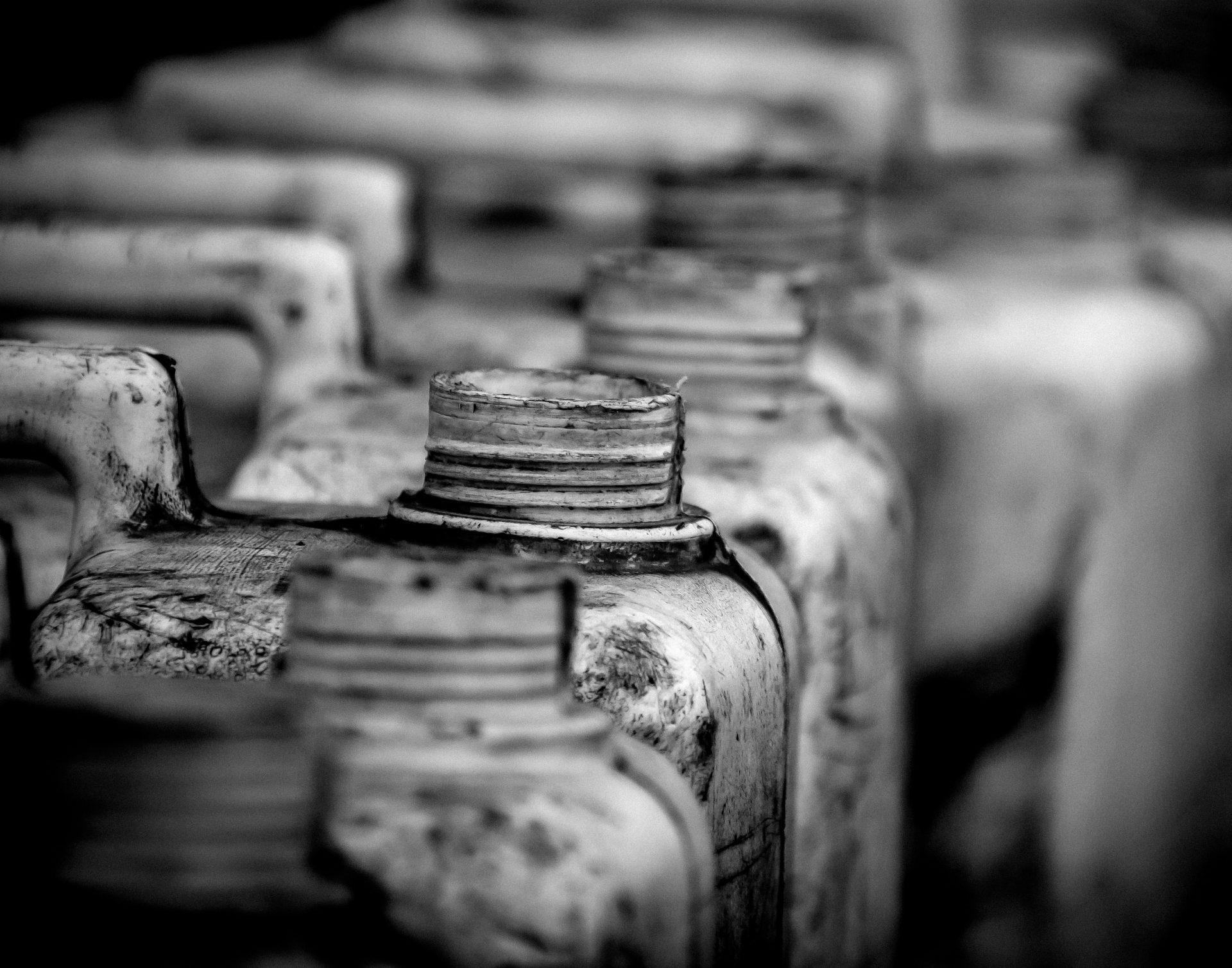 Close-up of old, dirty industrial canisters