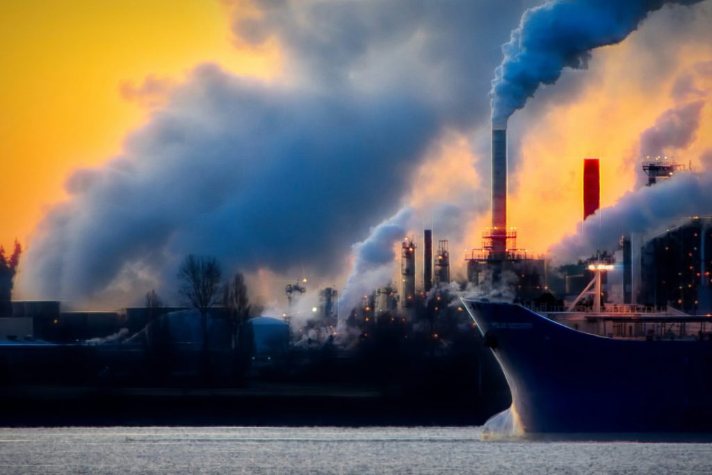 Industrial factory with heavy smoke during sunset