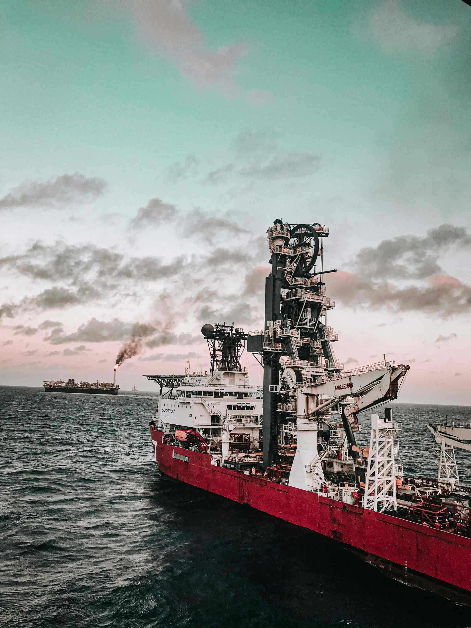 Offshore drilling ship at sea during sunset