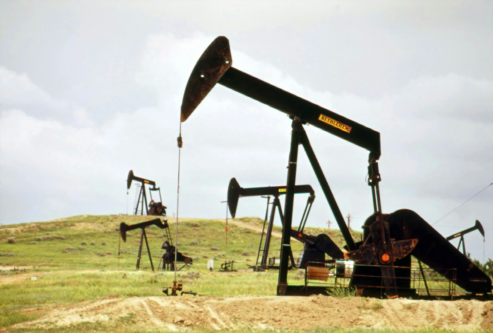 Oil pumps operating in a grassy field